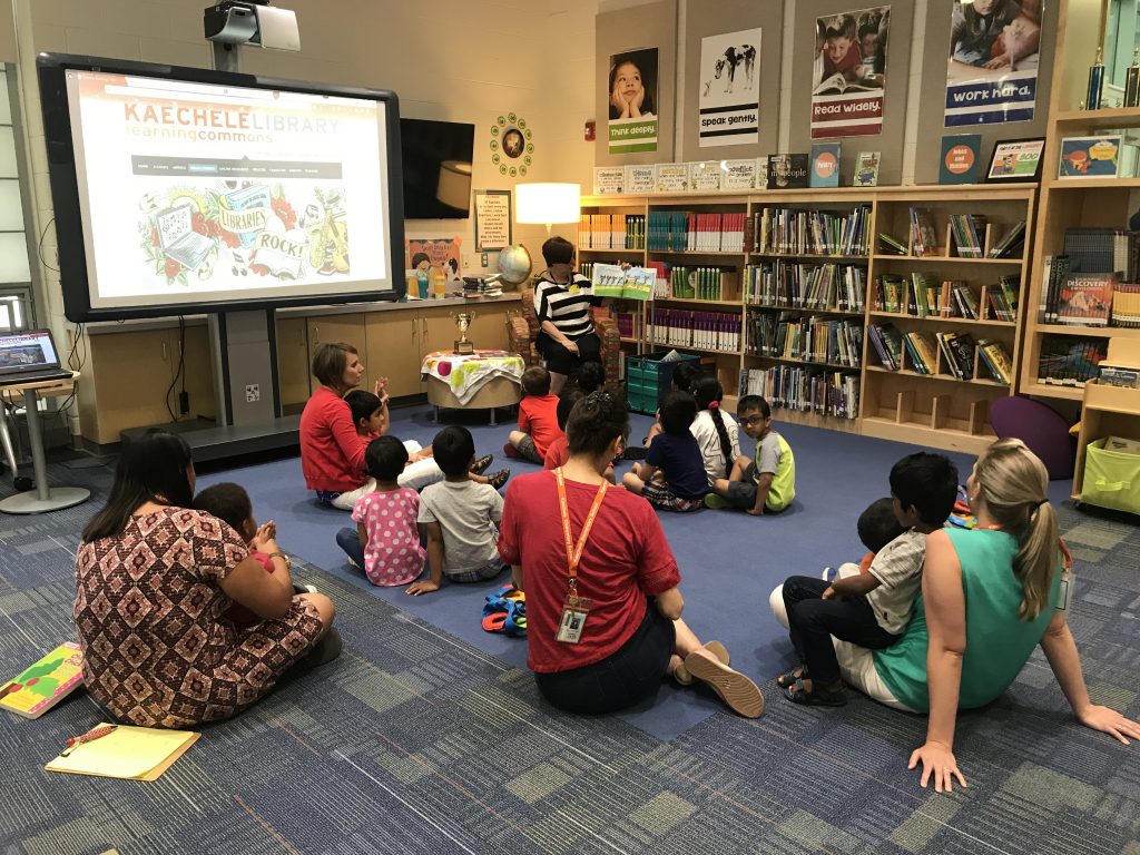 image of students listening to public librarian